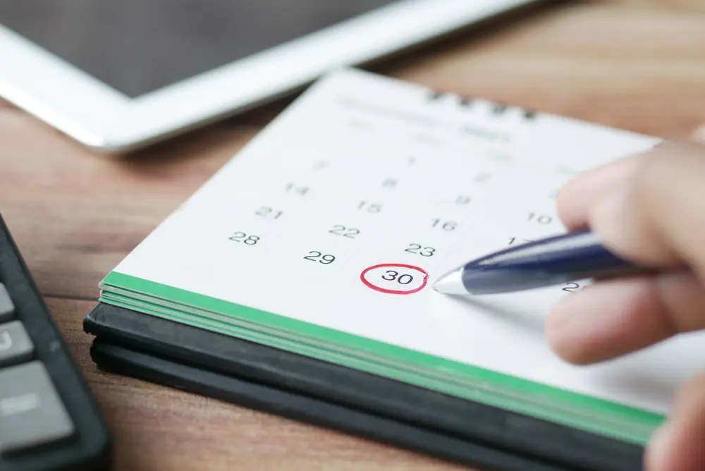 Hand circling a date on a desk calendar to plan around the Diwali 2026 bank holiday in their city