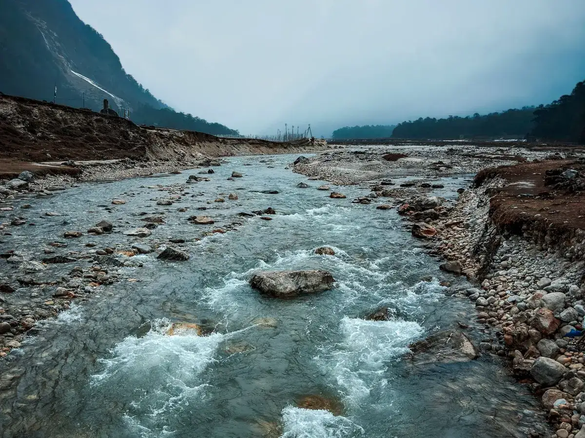 Fast-flowing Himalayan mountain river over rocks in Sikkim, India, a valley exposed to GLOF and flash flood risk